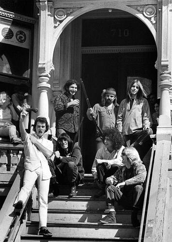 The Grateful Dead on the steps of their house the day after it was raided by narcotics agents in 1967