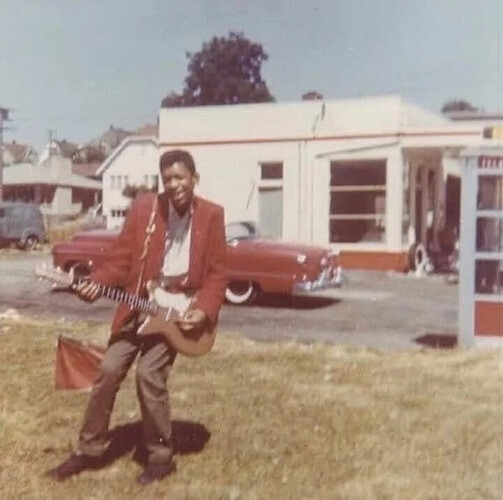 Jimi Hendrix posing with his first electric guitar