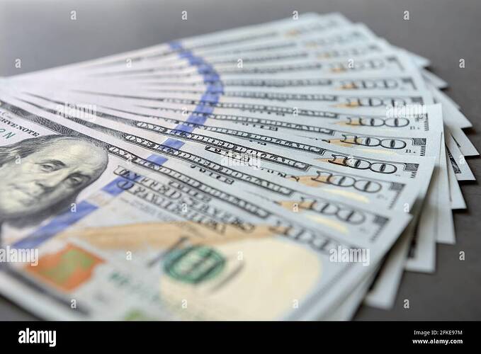 pile-of-one-hundred-dollar-banknotes-as-money-background-new-dollar-bills-spread-in-financial-concept-2FKE97M